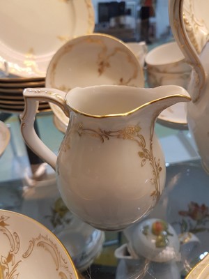 26724322e - Neuzierat coffee service, KPM Berlin, 20th century, porcelain, 1st choice, fine leaf and tendril decoration in gold painting, 9 cups with utensils, 9 plates, coffee pot, sugar bowl and cream jug, oval tray, 3 bowls, age- related damage