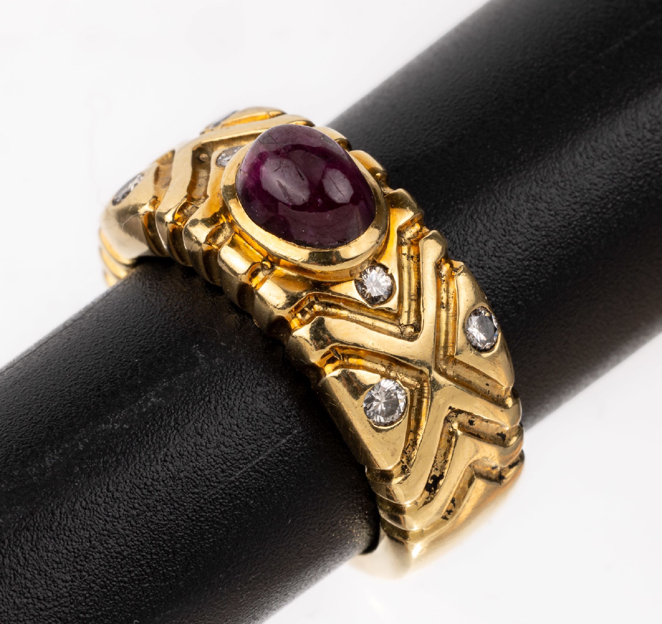 18 kt Gold Rubin-Brillant-Ring, GG 750/000,geometrische Gestaltung, mittig ovaler Rubin- Cabochon ca. 1.80 ct, 6 Brillanten zus. ca. 0.16 ct ...