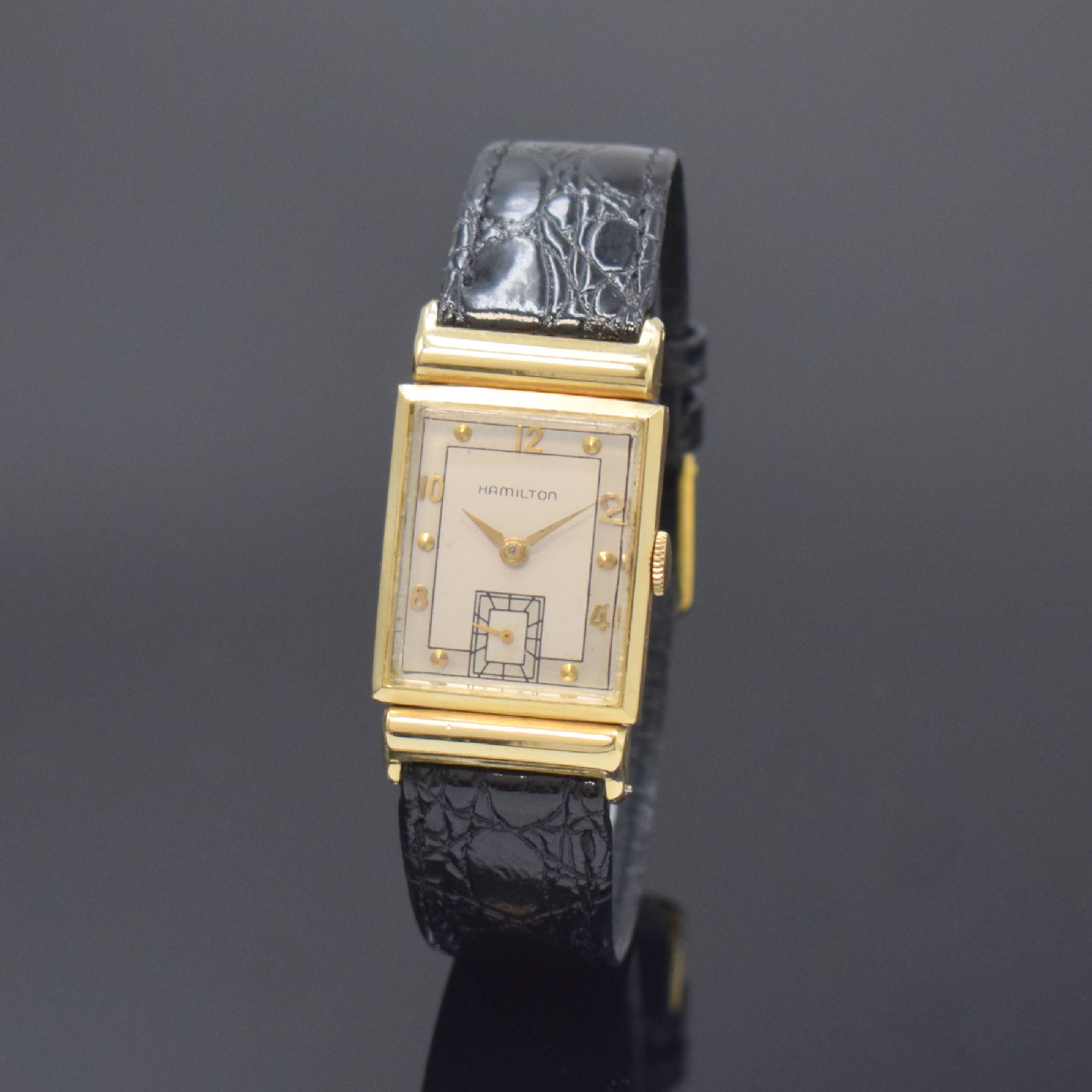 HAMILTON rechteckige Armbanduhr in 14k Gelbgold, USA um 1950, Handaufzug, 2-tlg. Geh. m. aufgedr. Boden dell., silb. Duoton- Zifferbl. rest., aufges. ...