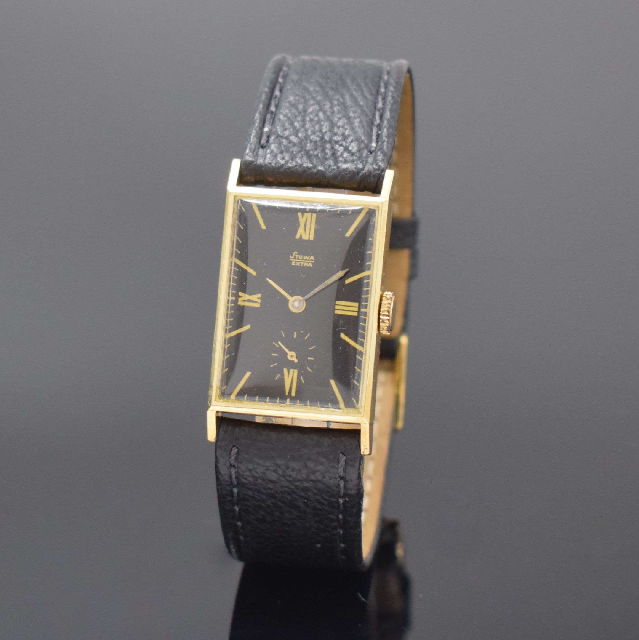STOWA Extra rechteckige Armbanduhr in GG 585/000, Deutschland / Schweiz um 1935, Handaufzug, Scharniergeh., schwarzes Glanz- Zifferbl., gold. röm. ...