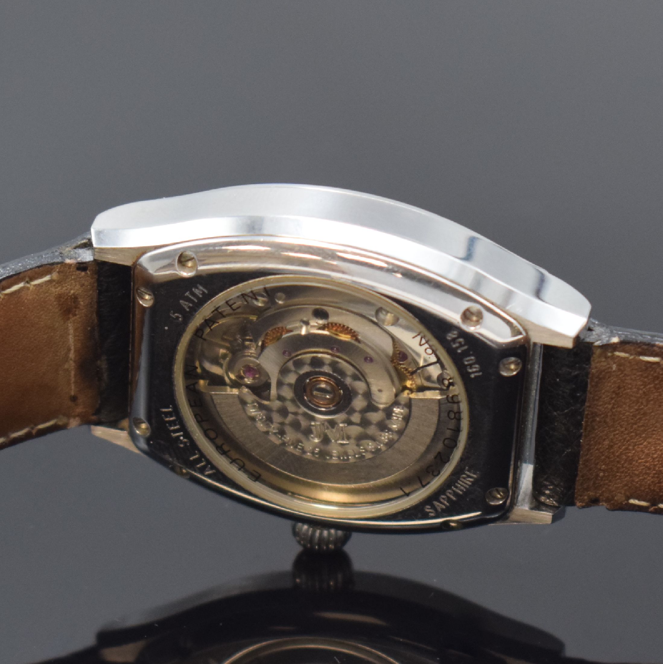 Detail e: JEAN MARCEL Herrenarmbanduhr mit wandernder springender Stunde Referenz 160.158, Schweiz um 1995, Automatik, tonneauförmiges, beids. vergl. ...