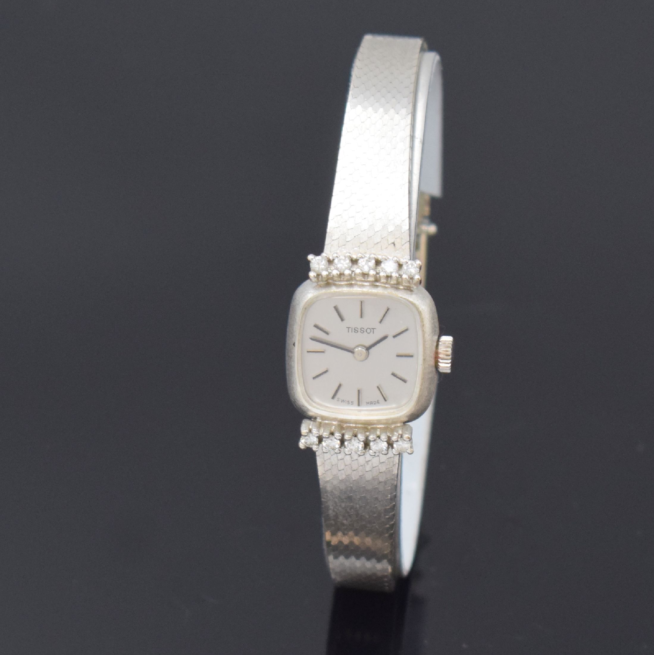 TISSOT Damenarmbanduhr in WG 585/000, Handaufzug, Schweiz um 1970, Geh. bei 6 und 12 mit 10 Diamanten bes., Boden aufgedr., vers. Zifferbl. m. ...