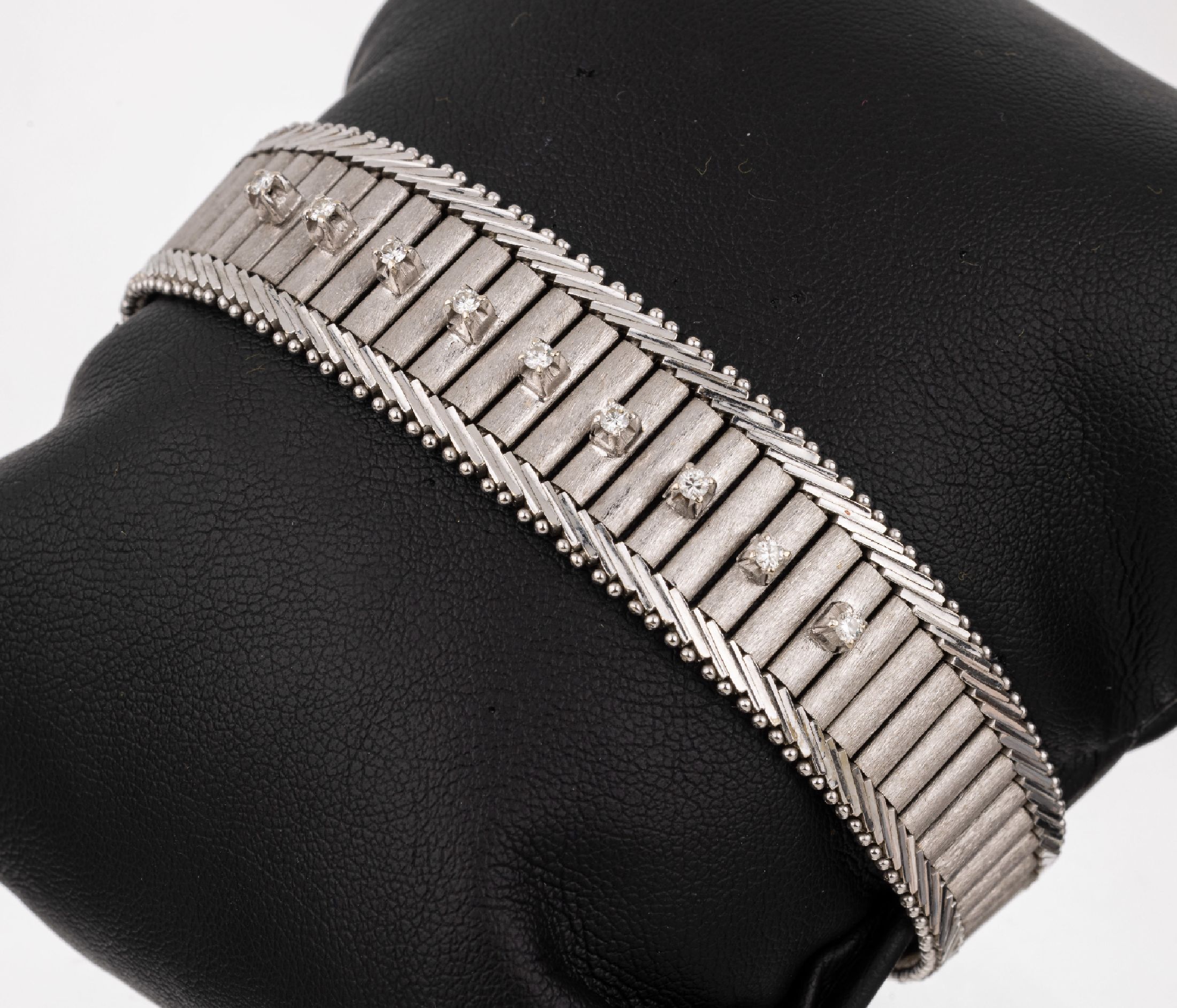 14 kt Gold Brillant-Armband, WG 585/000, imVerlauf, 9 erhaben gefasste Brillanten zus. ca. 0.22 ct Weiß/si, L. ca. 18 cm, ca. 32.7 g Kastenschloß ...
