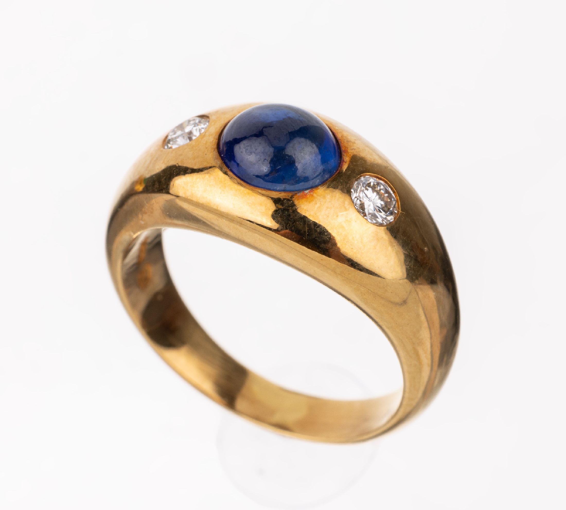 18 kt Gold Saphir-Brillant-Ring, GG 750/000, mittig ovaler Saphir-Cabochon ca. 1.70 ct, seitl. 2 Brillanten zus. ca. 0.21 ct feines Weiß/vvs, RW ...