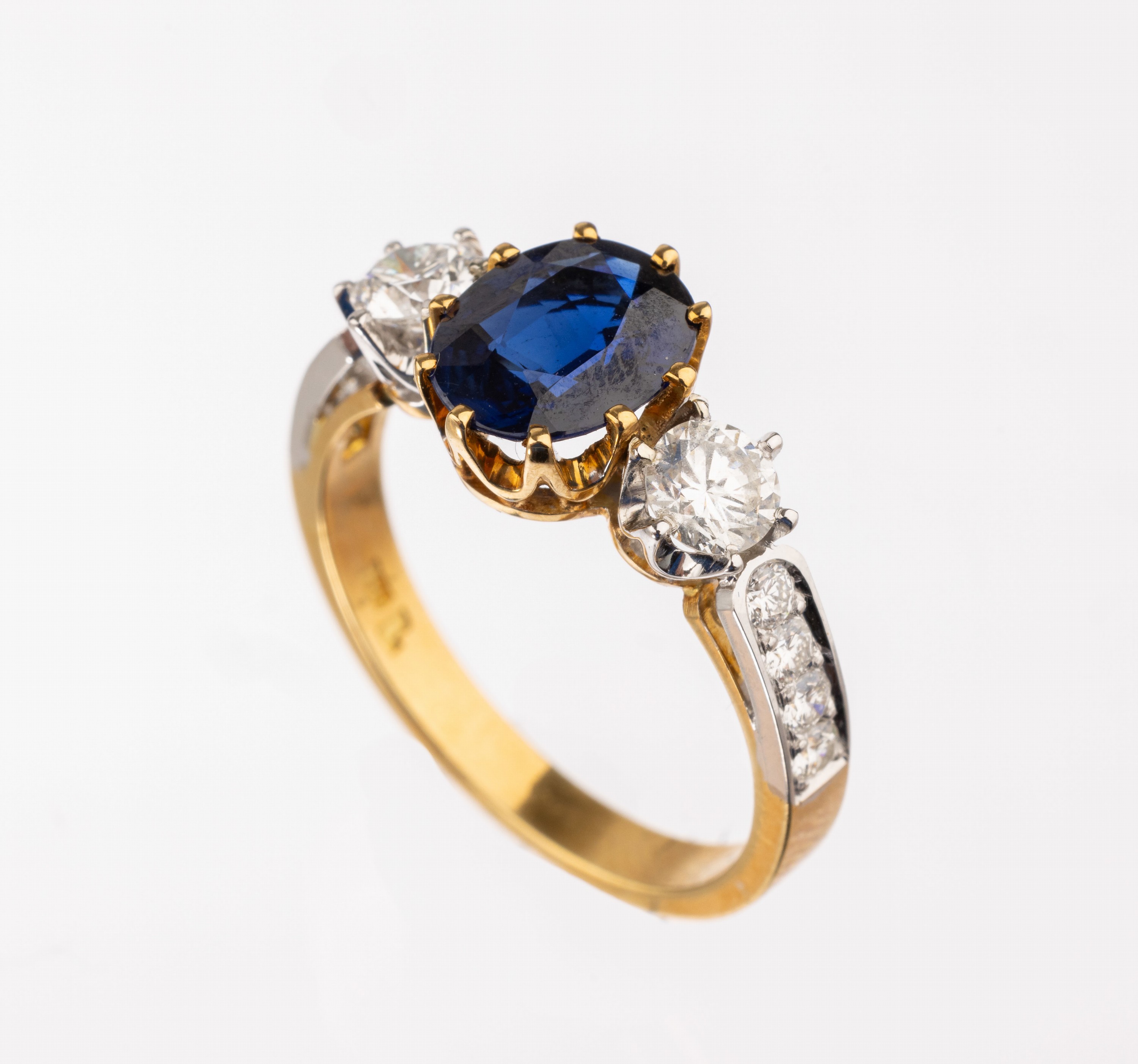 18 kt Gold Saphir-Brillant-Ring, GG/WG 750/000, mittig ovalfacett. Saphir von intensiver Farbe ca. 1.72 ct, 10 in WG gefasste Brillanten zus. ca. ...