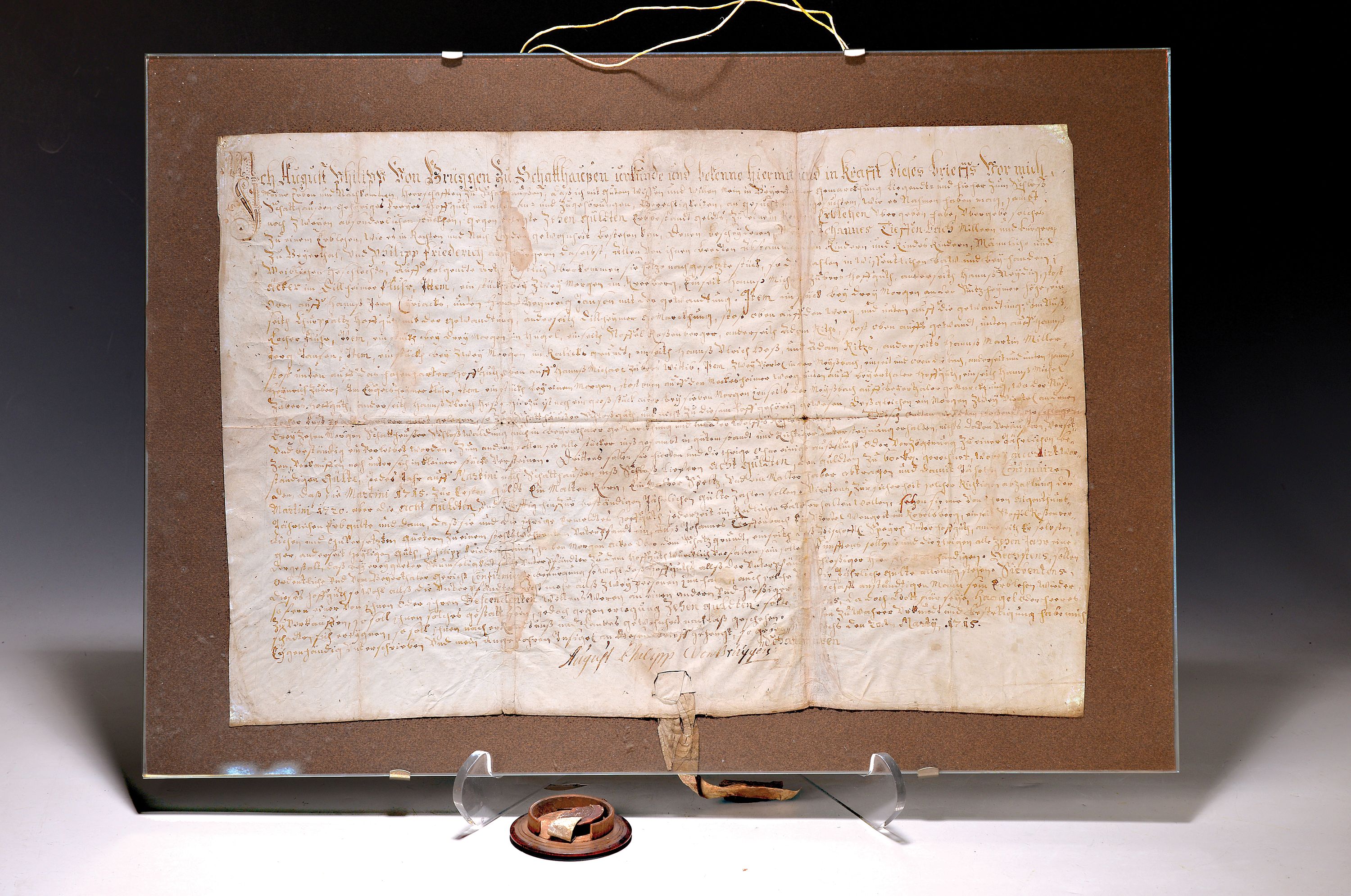 Urkunde August Philipp von Brüggen zu Schaffhausen, datiert März 1715, schwarze Tinte auf Papier, Rotwachssiegel in halber Holzkapsel gebrochen ...