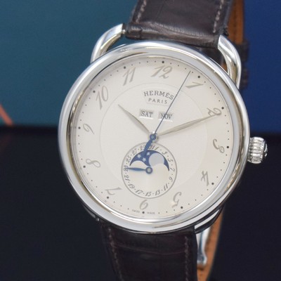 26732669a - HERMES wristwatch series Arceau Grande Lune reference AR8.810, self winding, stainless steel case including original leather strap with original deployant clasp, on both sides glazed, case back 5-times screwed down, silvered dial with Arabic hours, display of hours, minutes, day, date, month & moon phase, diameter approx. 43 mm, Hermes storage back enclosed, unworn stock, condition 1-2
