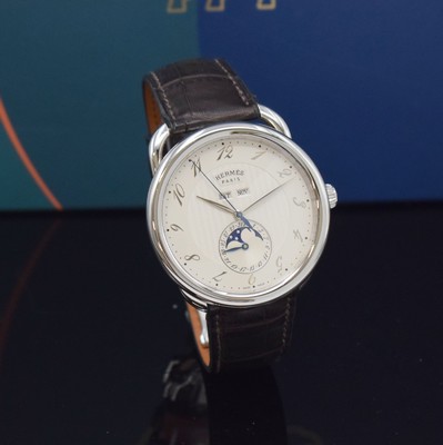 26732669b - HERMES wristwatch series Arceau Grande Lune reference AR8.810, self winding, stainless steel case including original leather strap with original deployant clasp, on both sides glazed, case back 5-times screwed down, silvered dial with Arabic hours, display of hours, minutes, day, date, month & moon phase, diameter approx. 43 mm, Hermes storage back enclosed, unworn stock, condition 1-2