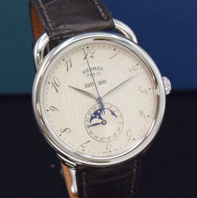 26732669c - HERMES wristwatch series Arceau Grande Lune reference AR8.810, self winding, stainless steel case including original leather strap with original deployant clasp, on both sides glazed, case back 5-times screwed down, silvered dial with Arabic hours, display of hours, minutes, day, date, month & moon phase, diameter approx. 43 mm, Hermes storage back enclosed, unworn stock, condition 1-2