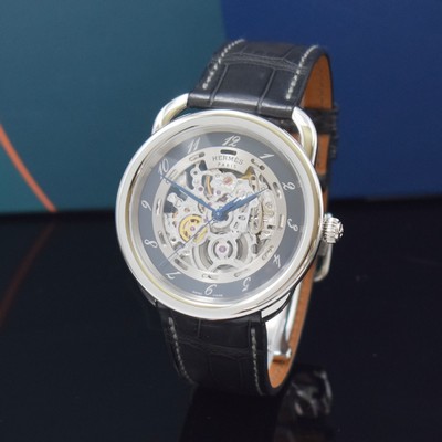 Image HERMES wristwatch series Arceau Squelette reference AR6.710a, self winding, stainless steel case including original leather strap with original deployant clasp, on both sides glazed case back 5-times screwed down, skeletonized glazed movement, gray outer ring with Arabic hours, display of hours, minutes & sweep seconds, diameter approx. 41 mm, Hermes storage back enclosed, unworn stock, condition 1-2