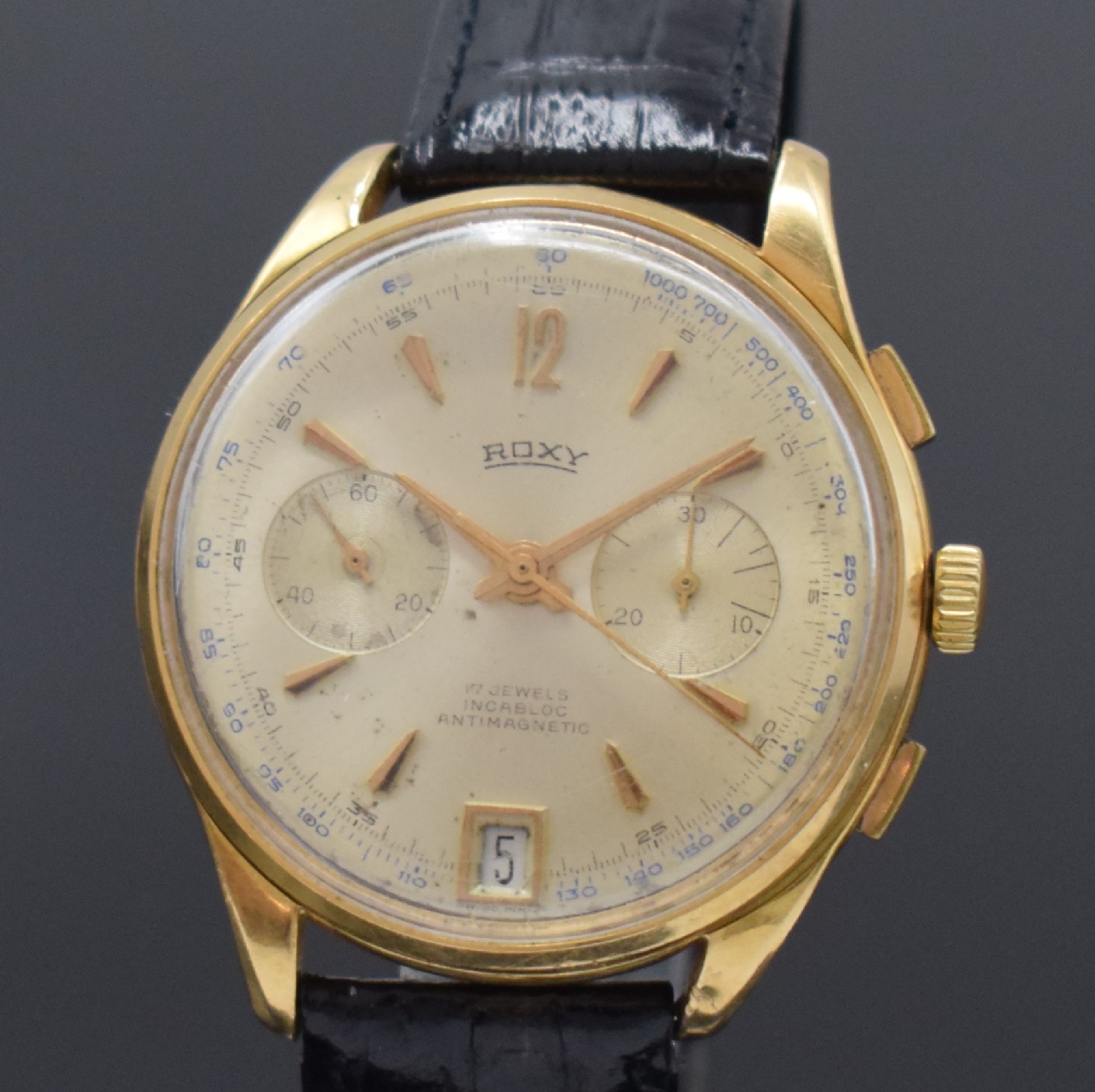 Detail a: ROXY Herrenchronograph in RG 750/000 mit Datum, Schweiz um 1960, Handaufzug, Boden u. Glasrand aufgedr., silb. Zifferbl. pat./fl., gold. Std.-Ind., ...