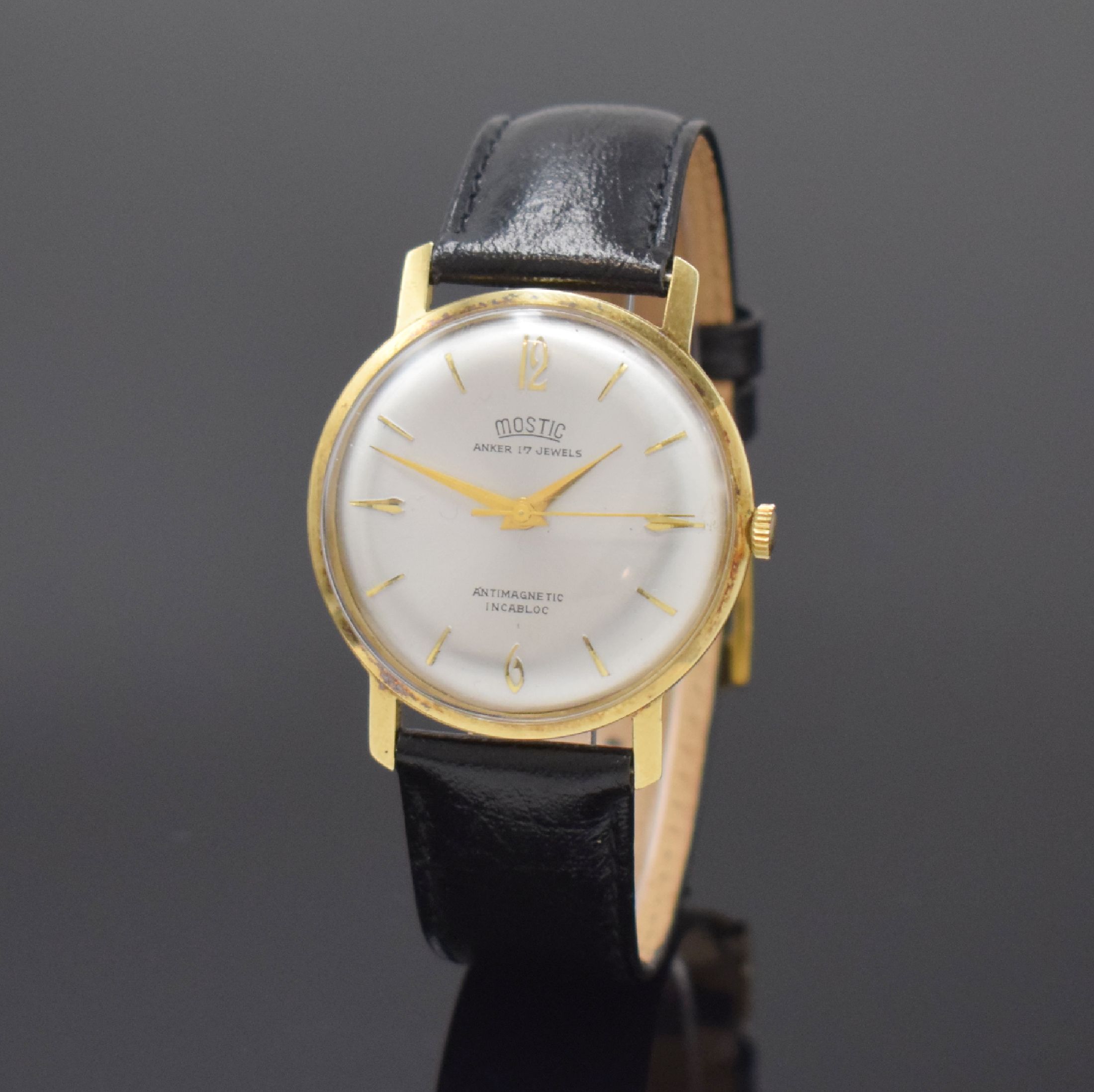 MOSTIC Armbanduhr in GG 585/000, Schweiz um 1965, Handaufzug, gedr. Boden in Metall/GG 585/000, silb. Zifferbl. m. gold. Std.-Ind., gold. Zeiger, ...