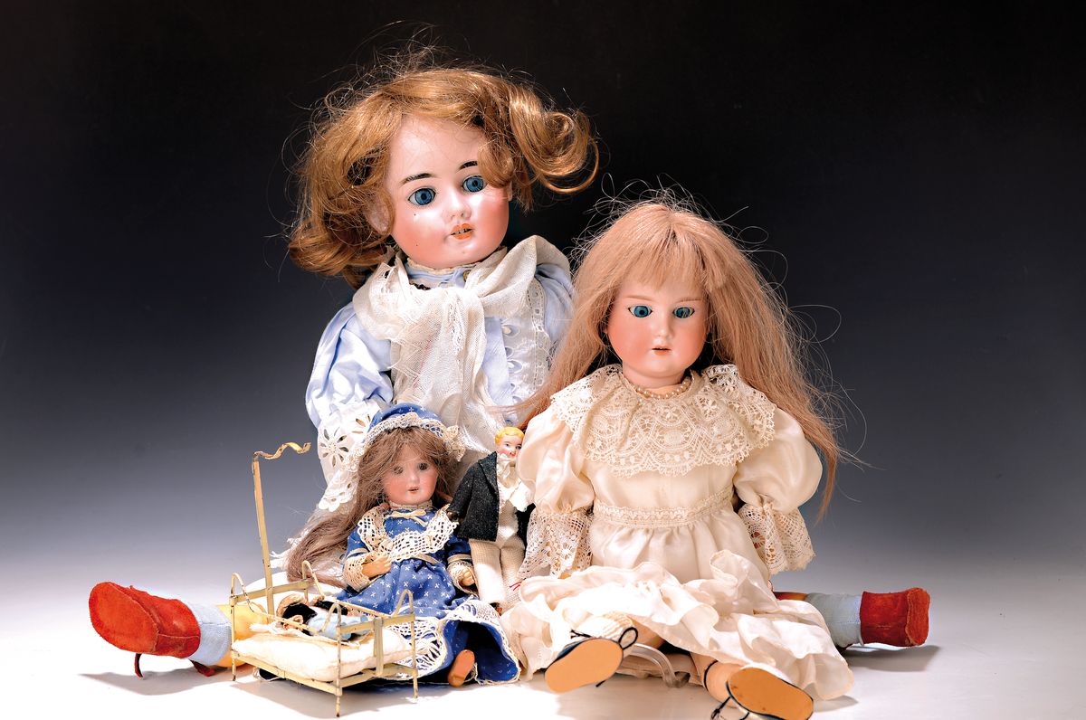5 Puppen und ein Bettchen, um 1910-20,, zwei große Porzellankopfpuppen: a. A.C. Anger 1904-10, Kurbelkopf, blaue Schlafaugen, vier Zähne oben, ...
