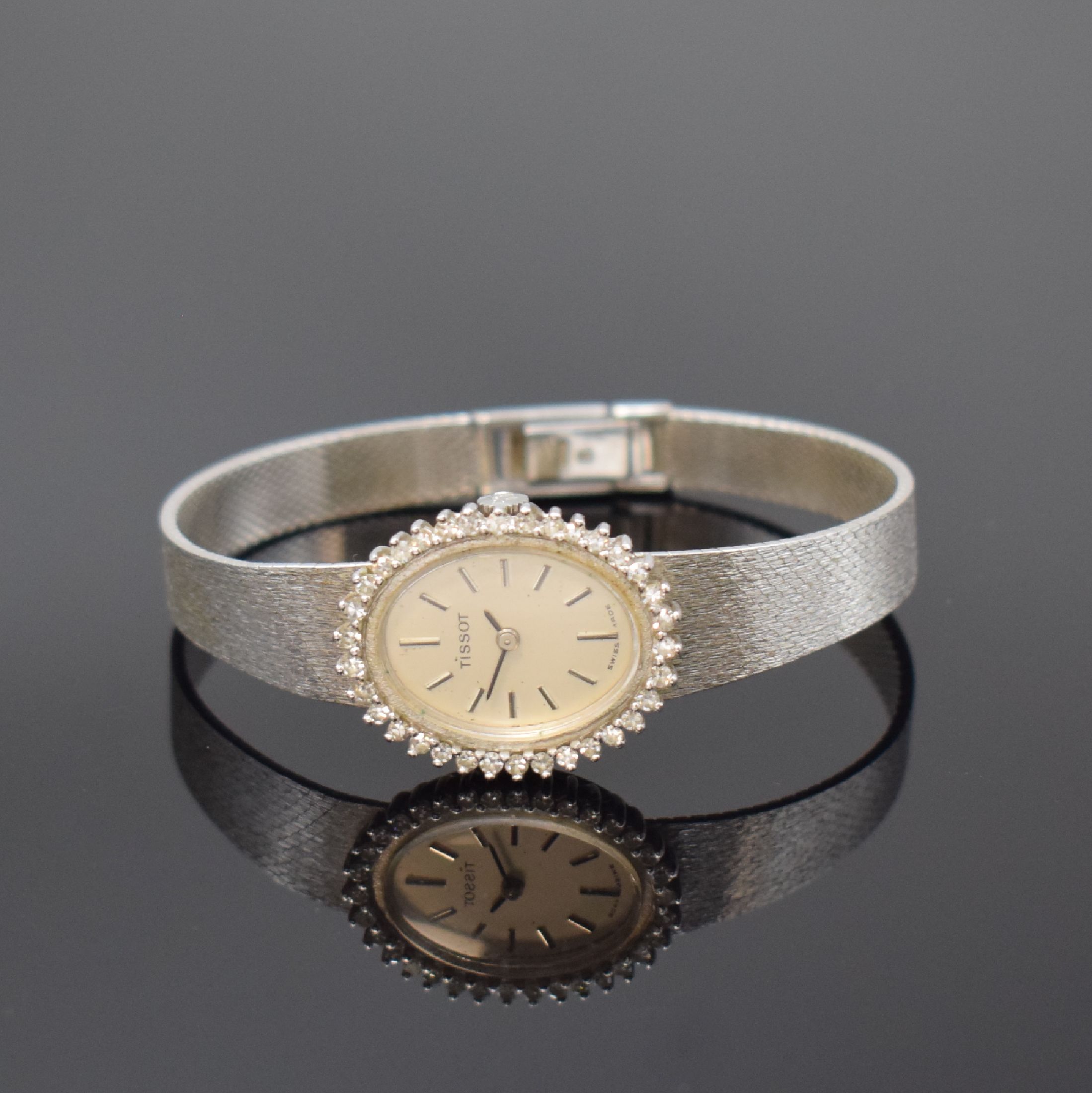 TISSOT Damenarmbanduhr in WG 585/000 mit Diamanten, Schweiz um 1970, Handaufzug, Boden aufgedr., Lünette aufw. m. Diamanten bes., vers. Zifferbl. m. ...