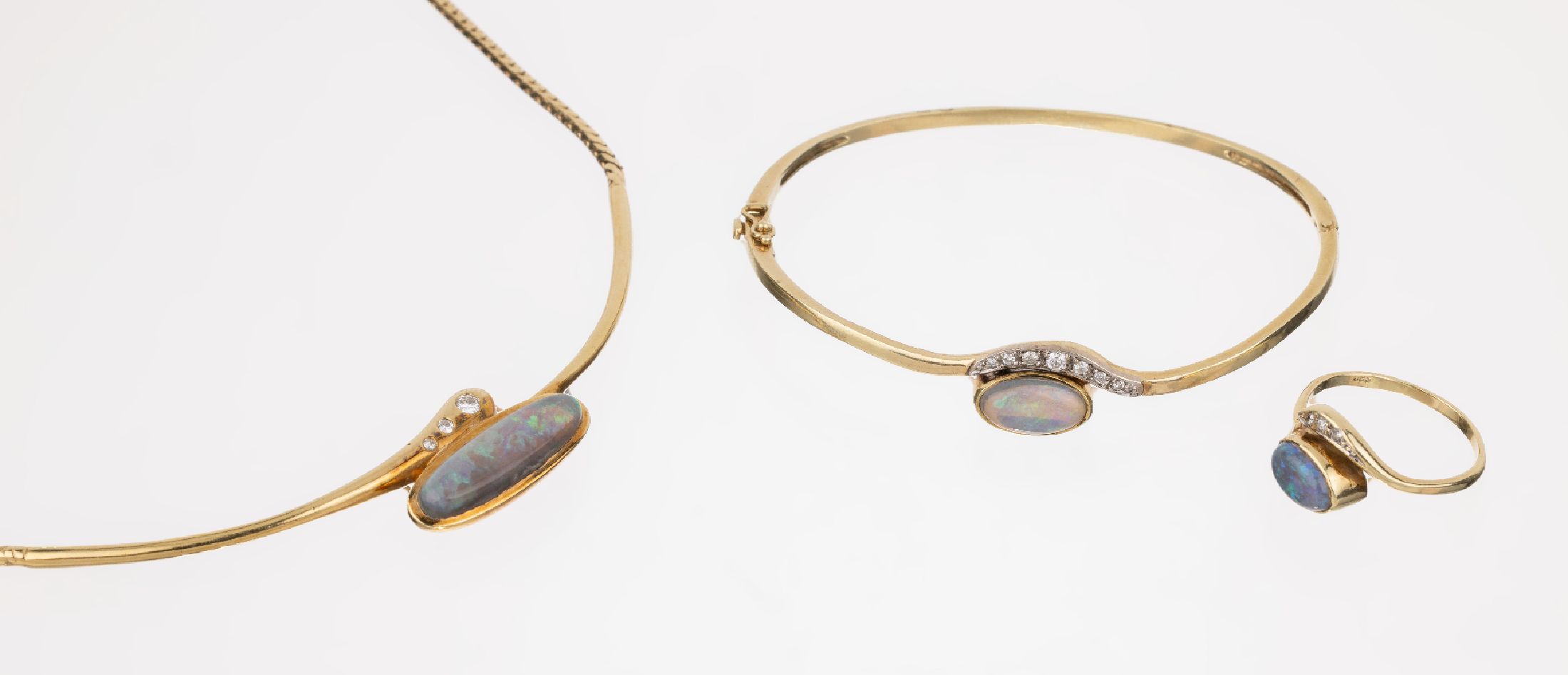 14 kt Gold Opal-Brillant-Schmuckset, GG 585/000, best. aus: 1 Collier, L. ca. 40 cm, 1länglich ovaler Opalcabochon, 3 Brillanten zus. ca. 0.08 ct ...
