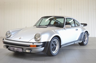 Image 26735668 - Porsche 930 Turbo, chassis number: 9307700060, engine number: 6770053, year of manufacture 09/1976, mileage approximately 157.767 km, historic registration, 260 hp, 6-cylinder, manual transmission, silver exterior, black leather interior, equipped with air conditioning and electric sunroof. Originally delivered by Porsche Düsseldorf in Germany, it comes with the Porsche Certificate of Authenticity. This vehicle is a coveted UR- TURBO and one of only 644 produced in 1976. A Classic Data assessment from 2014/15 documents and evaluates the full restoration, including: body, paintwork, interior, fuel supply, engine, transmission, axles, brakes, electrics, wheels and tires, glass, chrome, and seals, achieving a condition rating of 1.75. Since 2017, it has been part of a private collection and has been driven less than 1,500 km in the past 7 years