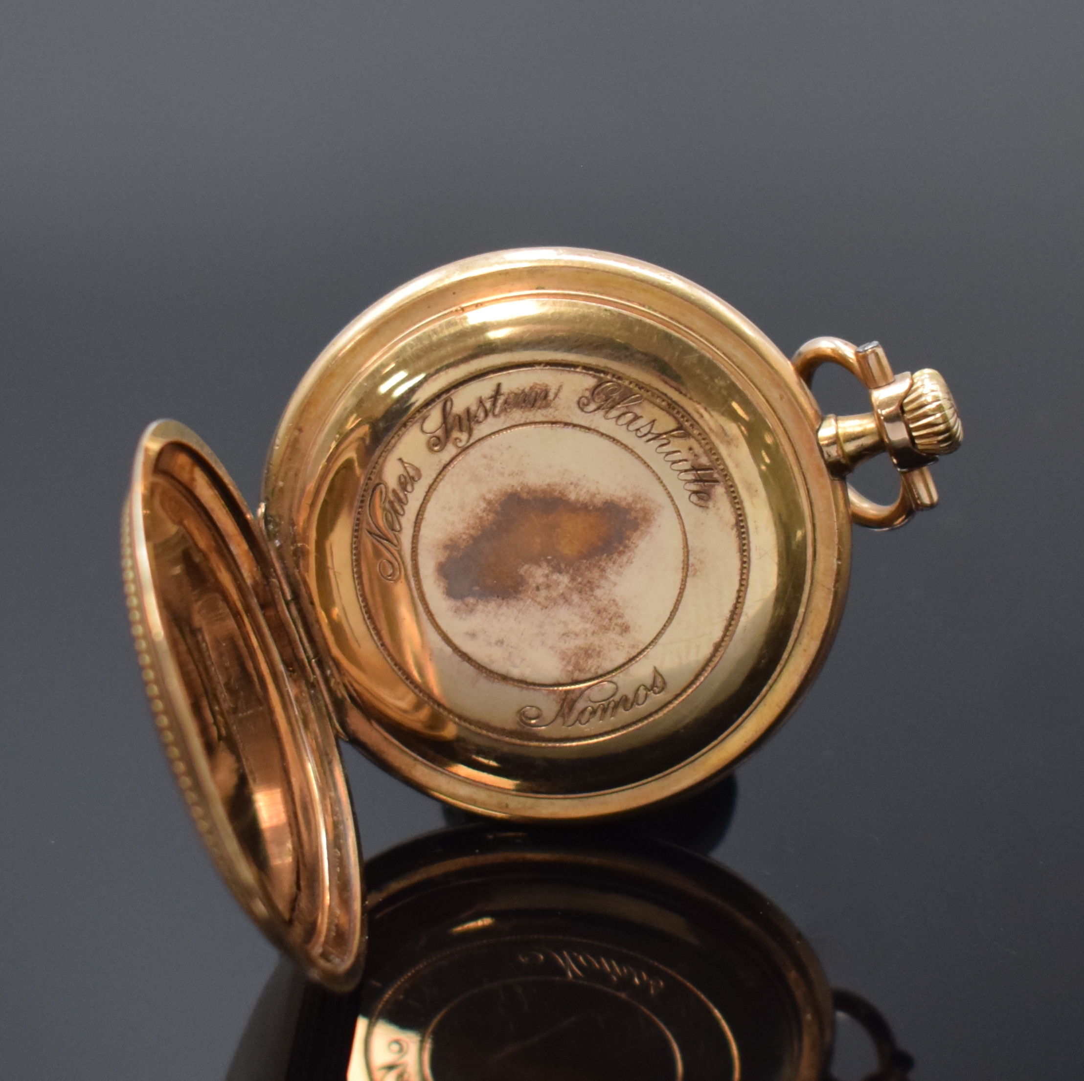 Detail c: NOMOS offene vergoldete Taschenuhr, Deutschland um 1910, verg. Geh. dell., guill. Rückdeckel, verg. Cuvette, Emailzifferbl. riss., sign. ...
