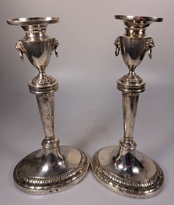 26739351b - Pair of classicism silver candlesticks, Augsburg, Johann Christian Neuss (1766-1803), year mark 1802, silver, oval plinth with leaf tip frieze, smooth conical shaft, spout in the form of a crater vase with a pair of lion heads, l. bent, height approx. 26.5 cm each, master's mark ICN in the oval, 676g