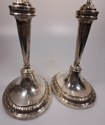 26739351d - Pair of classicism silver candlesticks, Augsburg, Johann Christian Neuss (1766-1803), year mark 1802, silver, oval plinth with leaf tip frieze, smooth conical shaft, spout in the form of a crater vase with a pair of lion heads, l. bent, height approx. 26.5 cm each, master's mark ICN in the oval, 676g