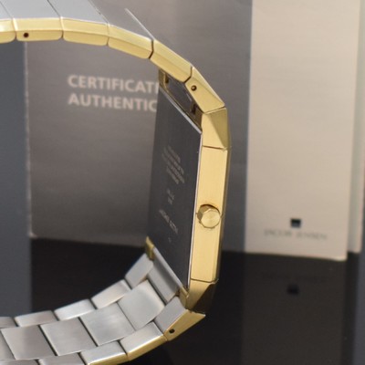 26745184c - JACOB JENSEN design-wristwatch reference 553 in steel, Switzerland according to original papers sold in 2018, quartz, rectangular case, integrated solid bracelet with butterfly clasp, bracelet and case with gold plated edges, silvered dial, gilded hands, date at 12, measures approx. 38,5 x 30 mm, length approx. 19 cm, condition 2