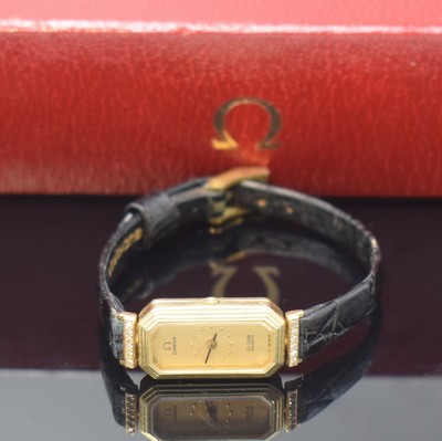 Image 26745572 - OMEGA De Ville diamond-set 14k yellow gold ladies wristwatch, Switzerland around 1980, quartz, baguette-shaped, octagonal case, fixed lugs, stepped bezel, snap on case back, gilded dial spotty, black hands, Omega-box enclosed, measures approx. 29 x 13 mm, condition 2-3