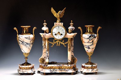 Image 26745598 - coat clock with candle holder, France around 1920/30, veined marble, profiled and curved base, eagle crown, pine cones, glass lid in front and behind, enamel dial with floral arcades, pendulum movement according to: Ad. Mougen, the striking mechanism does not start,sun pendulum, key unsuitable, height approx. 43cm, condition of movement 3-4, housing 2