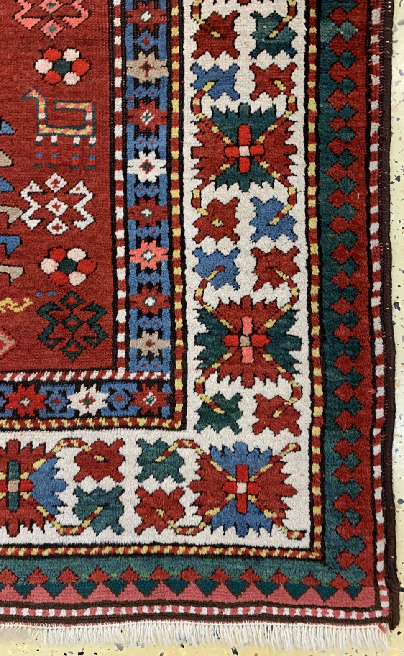 Detail a: Antiker Kazak, Kaukasus, 19.Jhd, Wolle auf Wolle, ca. 174 x 134 cm, EHZ: 2(beide Enden fachmänisch restauriert).