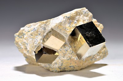 Image 26746876 - 3 pyrite cubes in the parent rock from Navajun(Spain), one large cube 2.3 x 2.3 cm, 2 small 1.6 x 1.6 cm parent rock 9 x 9 x 5.5 cm, 460 gPyrite forms cubic (cube-shaped) crystals, butonly one site in the world provides such perfect pyrite cubes: Navajun in Spain; nowhere else in the world does pyrite occur inthis beautiful and almost perfect form. Pyritespecimens from this site are represented in all major museum mineral collections. The pyrite cubes were created completely naturally. The surfaces were not ground but simply prepared from the parent rock