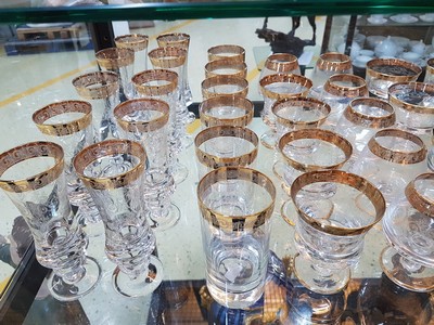 26748670a - Drinking glass service, Murano, 1960s/70s, 10 champagne glasses, 6 champagne bowls, 4 wine glasses, 6 cognac snifters, 6 tumblers, colorless glass, etched decor, gold rims, a few glasses without gold rims on the foot