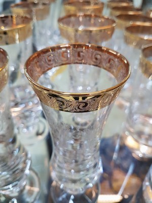 26748670c - Drinking glass service, Murano, 1960s/70s, 10 champagne glasses, 6 champagne bowls, 4 wine glasses, 6 cognac snifters, 6 tumblers, colorless glass, etched decor, gold rims, a few glasses without gold rims on the foot