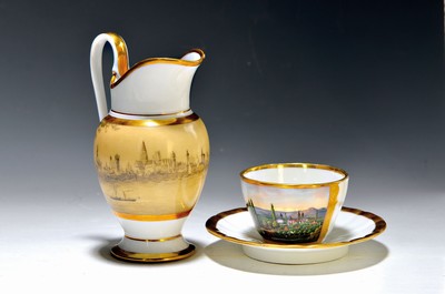 Image 26750548 - Milk jug and cup with saucer, Biedermeier, around 1820/30, porcelain, gold decoration, height approx. 18/7 cm, jug with a fine surrounding city view on the river, with paddle steamer, in Griseille painting on a beige background, cup with colorful painting, City view in front of slight hills, both with slight traces of usage