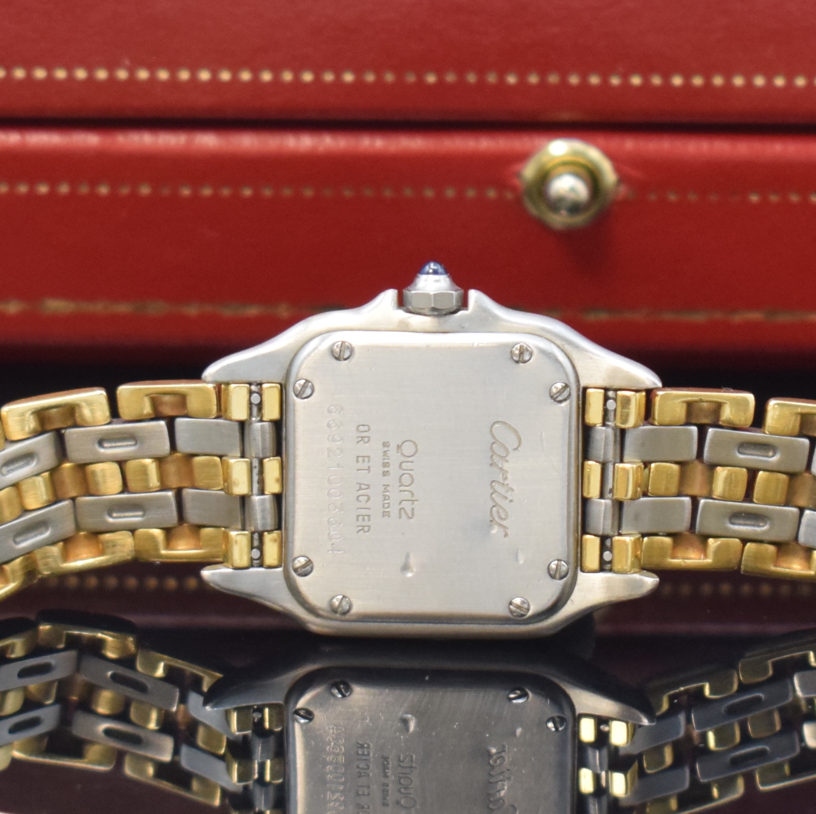 Detail e: CARTIER Panthere Damenarmbanduhr in Stahl/Gold, Schweiz um 1990, quarz, Boden 8-fach verschr., orig. Gliederband m. dopp. Faltschl., vers. Zifferbl. ...