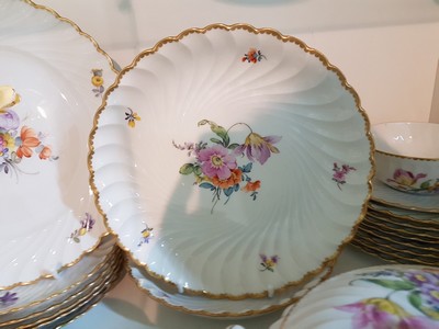 26755347c - Dinner service, Nymphenburg, wave shape, 20th century, porcelain, hand-painted decoration of scattered flowers and bouquets of flowers, gold rim, 8 soup bowls with utensils, 8 dinner plates, 8 bread plates, 2 small bowls, 2 side dish bowls, 2 gravy boats, lidded tureen, traces of age