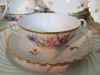 26755347d - Dinner service, Nymphenburg, wave shape, 20th century, porcelain, hand-painted decoration of scattered flowers and bouquets of flowers, gold rim, 8 soup bowls with utensils, 8 dinner plates, 8 bread plates, 2 small bowls, 2 side dish bowls, 2 gravy boats, lidded tureen, traces of age