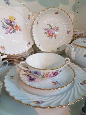 26755347g - Dinner service, Nymphenburg, wave shape, 20th century, porcelain, hand-painted decoration of scattered flowers and bouquets of flowers, gold rim, 8 soup bowls with utensils, 8 dinner plates, 8 bread plates, 2 small bowls, 2 side dish bowls, 2 gravy boats, lidded tureen, traces of age