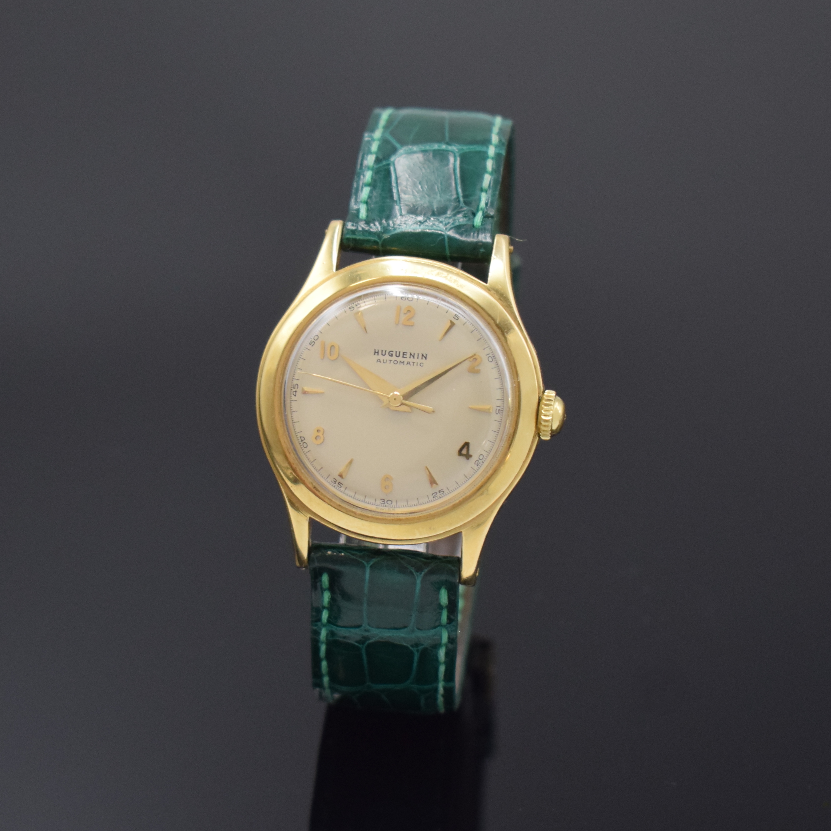 HUGUENIN Automatic verschraubte Armbanduhr in GG 750/000, Schweiz um 1955, massives 2-tlg. Geh., silb. orig. Zifferbl., aufges. gold. Indizes, gold. ...
