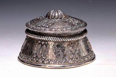 Image 26761021 - Silver lidded box, Tibet, early 20th century, silver tested, conical shape, flat ornamental decoration with partly zoomorphic shapes, chased and engraved, diameter 13 cm, 394g