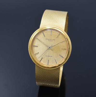 Image 26762562 - PATEK PHILIPPE / GÜBELIN fine 18k yellow gold gents wristwatch reference 3563/3, self winding, Switzerland 1975, milanaise bracelet, so called Backwinder, hand-setting on the back side, screwed down case back, gilded structured dial with raised indices, display of hours, minutes and sweep seconds, rhodium plated movement, calibre 350, Seal of Geneva, 28 jewels, fausses cotes decoration, Gyromax- balance, adjusted in 5 positions, Breguet- hairspring, diameter approx. 35 mm, length approx. 17,5 cm, signs of use due to age, overhaul recommended at buyer's expense, condition 2-3