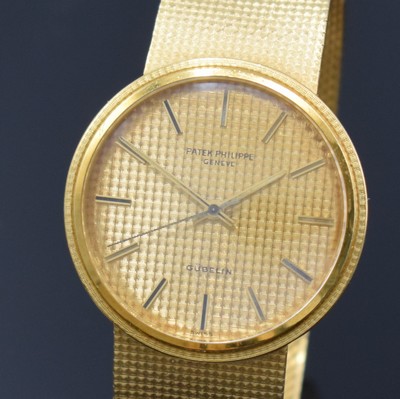 Image 26762562a - PATEK PHILIPPE / GÜBELIN fine 18k yellow gold gents wristwatch reference 3563/3, self winding, Switzerland 1975, milanaise bracelet, so called Backwinder, hand-setting on the back side, screwed down case back, gilded structured dial with raised indices, display of hours, minutes and sweep seconds, rhodium plated movement, calibre 350, Seal of Geneva, 28 jewels, fausses cotes decoration, Gyromax- balance, adjusted in 5 positions, Breguet- hairspring, diameter approx. 35 mm, length approx. 17,5 cm, signs of use due to age, overhaul recommended at buyer's expense, condition 2-3