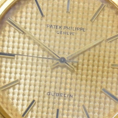 Image 26762562b - PATEK PHILIPPE / GÜBELIN fine 18k yellow gold gents wristwatch reference 3563/3, self winding, Switzerland 1975, milanaise bracelet, so called Backwinder, hand-setting on the back side, screwed down case back, gilded structured dial with raised indices, display of hours, minutes and sweep seconds, rhodium plated movement, calibre 350, Seal of Geneva, 28 jewels, fausses cotes decoration, Gyromax- balance, adjusted in 5 positions, Breguet- hairspring, diameter approx. 35 mm, length approx. 17,5 cm, signs of use due to age, overhaul recommended at buyer's expense, condition 2-3