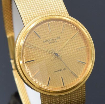 26762562d - PATEK PHILIPPE / GÜBELIN fine 18k yellow gold gents wristwatch reference 3563/3, self winding, Switzerland 1975, milanaise bracelet, so called Backwinder, hand-setting on the back side, screwed down case back, gilded structured dial with raised indices, display of hours, minutes and sweep seconds, rhodium plated movement, calibre 350, Seal of Geneva, 28 jewels, fausses cotes decoration, Gyromax- balance, adjusted in 5 positions, Breguet- hairspring, diameter approx. 35 mm, length approx. 17,5 cm, signs of use due to age, overhaul recommended at buyer's expense, condition 2-3