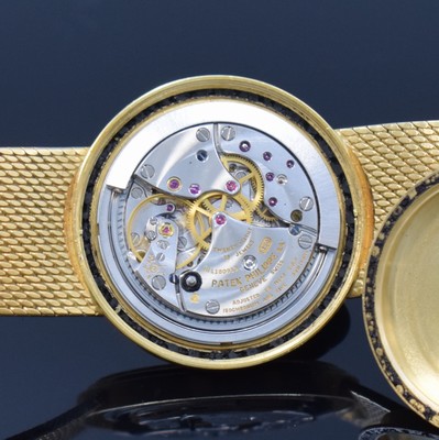 26762562f - PATEK PHILIPPE / GÜBELIN fine 18k yellow gold gents wristwatch reference 3563/3, self winding, Switzerland 1975, milanaise bracelet, so called Backwinder, hand-setting on the back side, screwed down case back, gilded structured dial with raised indices, display of hours, minutes and sweep seconds, rhodium plated movement, calibre 350, Seal of Geneva, 28 jewels, fausses cotes decoration, Gyromax- balance, adjusted in 5 positions, Breguet- hairspring, diameter approx. 35 mm, length approx. 17,5 cm, signs of use due to age, overhaul recommended at buyer's expense, condition 2-3