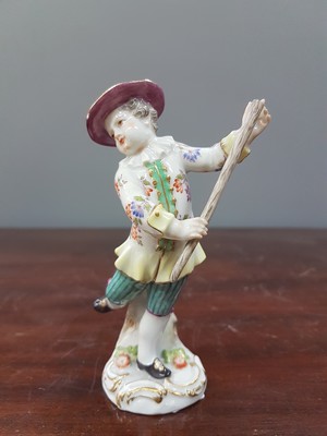 26765613a - Porcelain figure, Meissen, early 20th century, on staff and hat slightly dam., porcelain, colorfully painted, gold decoration, height approx. 11.5 cm