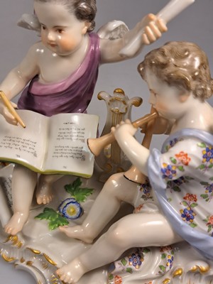 26765618h - Porcelain group, Meissen, around 1890/1900, allegory of poetry, designed by Johann Joachim Kaendler, two musical cupids, model no. 2464, fine polychrome painting, gold decoration, pommel swords, approx. 12.5 x 16 cm