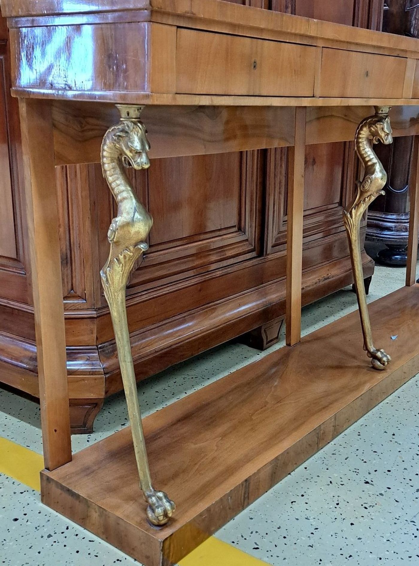 Detail b: Konsole/Anrichte, im Biedermeier-Stil, um 1900, Nußbaumfurnier, 4 Schubladen, Korpus wird getragen von vergoldeten fabelwesenartigen Seepferdchen, ...