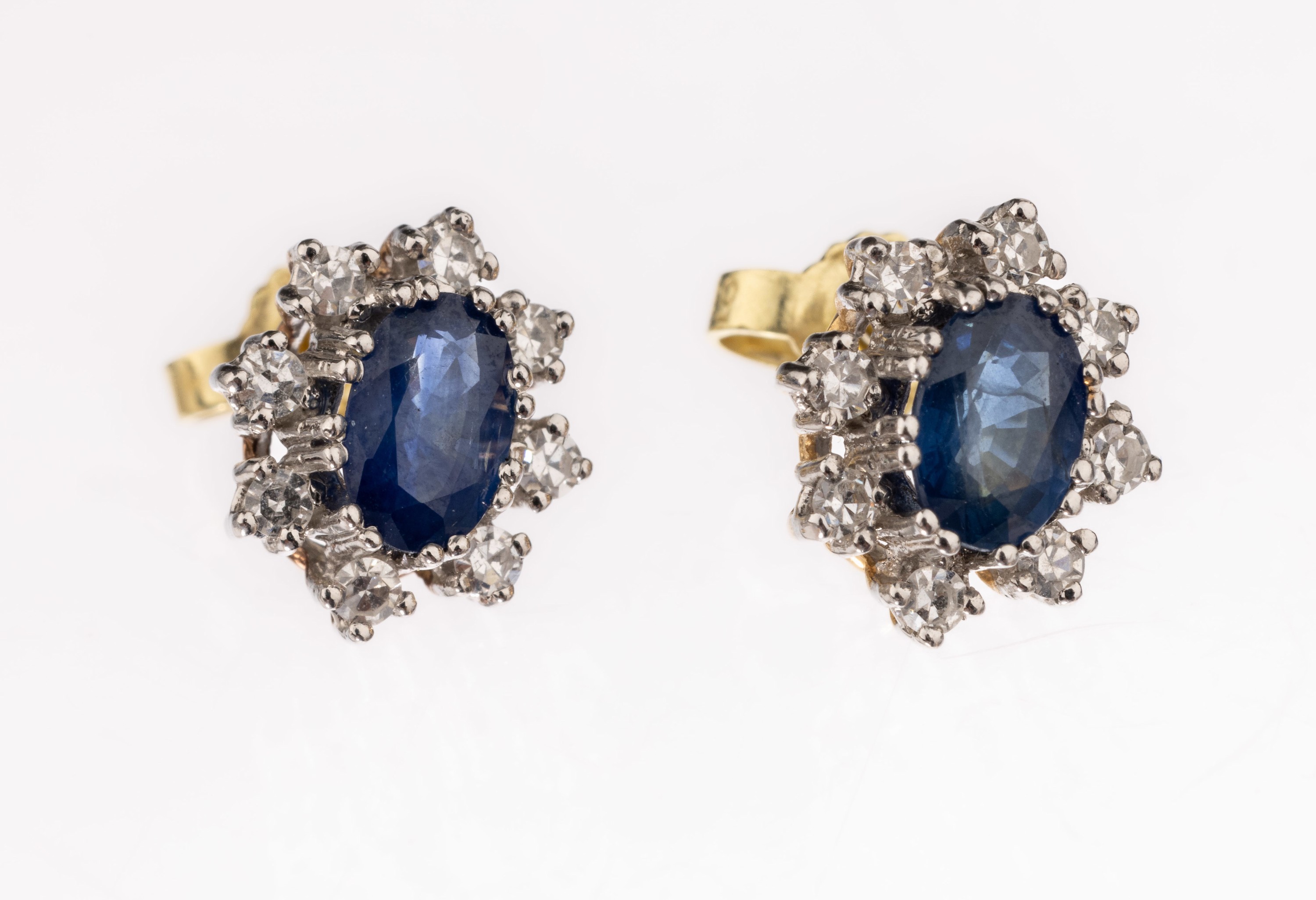 Paar 14 kt Gold Saphir-Diamant-Ohrstecker, GG/WG 585/000, 2 ovalfacett. Saphire zus. ca. 0.80 ct, 16 8/8-Diamanten zus. ca. 0.20 ct Weiß/vs-si