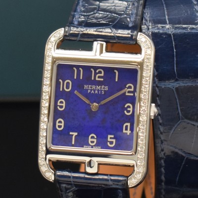 26766824a - HERMES wristwatch series Cape Cod reference CC3.730, quartz, stainless steel case including original leather strap with original buckle, case back screwed-down 4- times, case at the sides with diamonds, lapis lazuli-dial with Arabic numerals, silvered hands, measures approx. 40,5 x 29 mm, Hermes storage back enclosed, unworn stock, condition 1-2