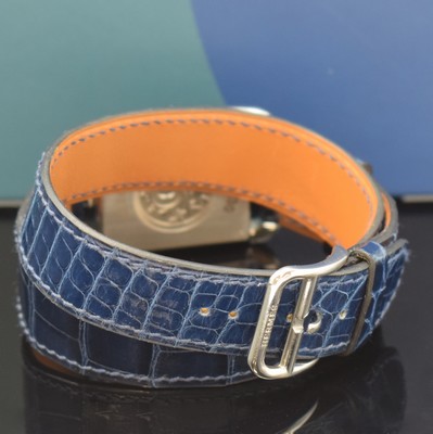 26766824b - HERMES wristwatch series Cape Cod reference CC3.730, quartz, stainless steel case including original leather strap with original buckle, case back screwed-down 4- times, case at the sides with diamonds, lapis lazuli-dial with Arabic numerals, silvered hands, measures approx. 40,5 x 29 mm, Hermes storage back enclosed, unworn stock, condition 1-2