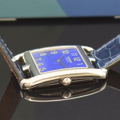 26766824c - HERMES wristwatch series Cape Cod reference CC3.730, quartz, stainless steel case including original leather strap with original buckle, case back screwed-down 4- times, case at the sides with diamonds, lapis lazuli-dial with Arabic numerals, silvered hands, measures approx. 40,5 x 29 mm, Hermes storage back enclosed, unworn stock, condition 1-2