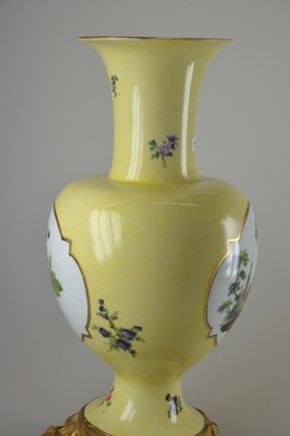 26768015e - Yellow background decorative vase, Meissen, 18th century, porcelain, yellow background, pair of picture cartouches with fine painting: Watteau scene on the front, flower bouquet on the back, scattered flowers, painting probably Isaac Jacob Clauce, a jour worked bronze foot with asymmetrical shell work, on the side of the foot marked, gold decoration, h. 32.5 cm, slightly rest.